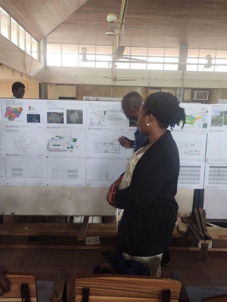 Oluyemisi reviewing a student’s boards at the master’s final design jury